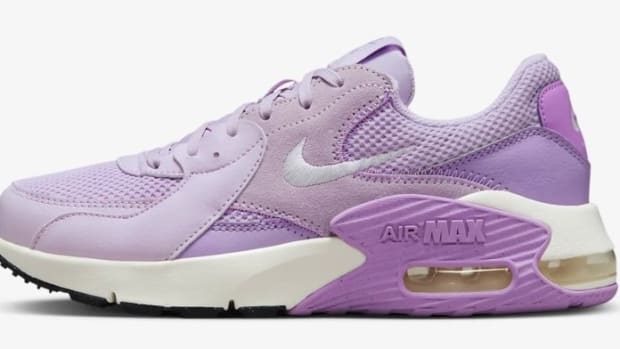 Side view of a pink and white Nike Air Max shoe.